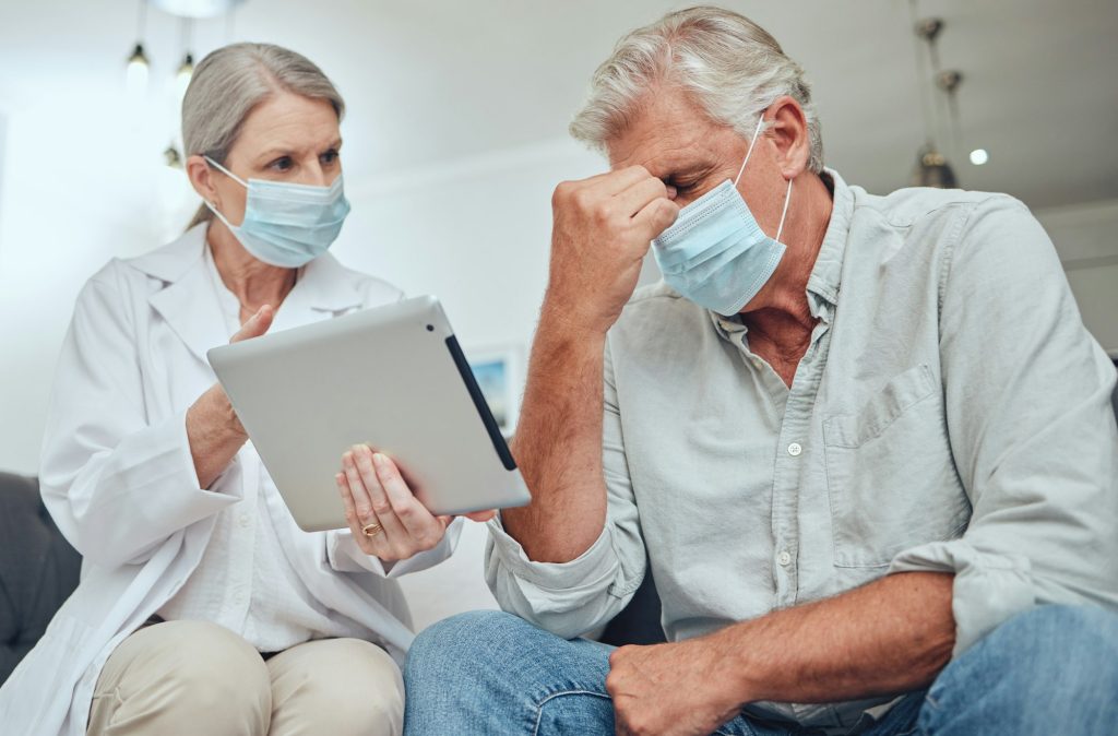 Healthcare, digital tablet and covid diagnosis by doctor and patient consulting at hospital. Medica